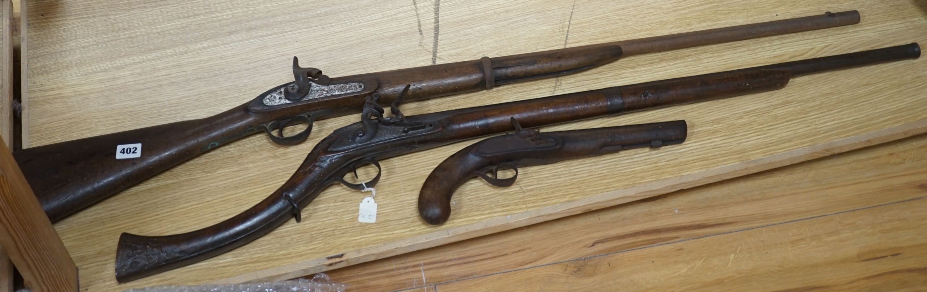 A Continental flintlock musket, a Victorian percussion musket stamped VR beneath a crown and Pimlico 1854 an incomplete 19th-century flintlock pistol